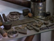 Different tools and samples at table in workshop, close-up — Stock Photo