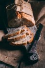 Rustic bread loaf and slices — Stock Photo