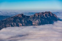 Rocky mountain peaks in clouds — Stock Photo