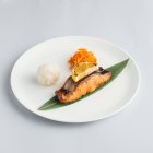 Composition with fried salmon and rice ball — Stock Photo