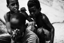 LA HABANA, CUBA - MAY 1, 2018: Black and white shot of ethnic children spending time on street of Cuba city in sunlight — Stock Photo