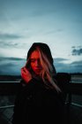 Blonde woman standing in dusk — Stock Photo