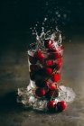 Fresh cherries in glass with ice — Stock Photo