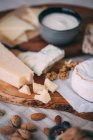Cheese board with different nuts — Stock Photo