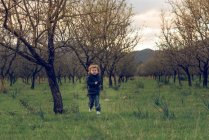 Boy running on sunny meadow — Stock Photo