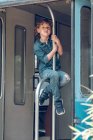 Junge sitzt auf Geländer in verlassenem Waggon — Stockfoto
