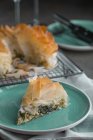 Piece of traditional greek spinach pie spanakopita on blue plate — Stock Photo