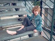 Barefoot boy standing on stairs — Stock Photo