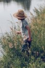 Boy standing at river — Stock Photo