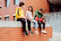 Teenagers with skateboards on fence — Stock Photo
