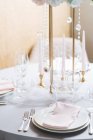 Round setting table in elegant style with white porcelain and crystal glasses — Stock Photo