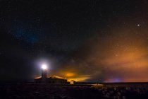 Leuchtturm leuchtet in der Nacht der Sterne. Cavalleria, Menorca, Spanien — Stockfoto