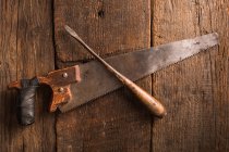Carpenter rusty tools on wooden surface — Stock Photo