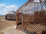 Exterior of traditional nomad tents yurtas on dry land of terrain, Uzbekistan — Stock Photo