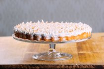 Хрусткий пиріг, увінчаний запеченим білим пухнастим злиттям на підставці для торта — стокове фото
