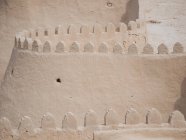 Perspective view of endless stone wall with walking passage on top in sunlight, Uzbekistan — Stock Photo