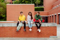 Adolescentes com skates na cerca — Fotografia de Stock