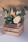 Wedding floral composition in wooden box — Stock Photo