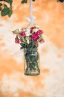 Wedding floral decoration in vase on tree — Stock Photo
