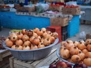 Bowls of fresh pomegranates at farmer market — Stock Photo
