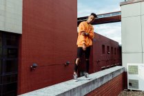 Young ethnic teenager on roof — Stock Photo