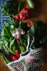 Fresh vegetables and greens on wooden table — Stock Photo