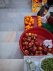 Fresh fruits on stairs on street market — Stock Photo