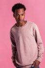 Hipster black man posing on pink background — Stock Photo
