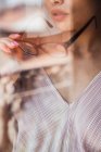 Close-up of alluring woman holding glasses with mouth slightly opened behind glass — Stock Photo