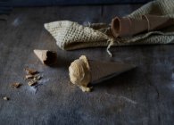 Leckeres Eis in knuspriger Zuckertüte auf grauem Holztisch — Stockfoto