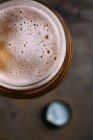 Primer plano del vaso de cerveza sobre fondo oscuro - foto de stock