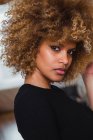 Portrait of young ethnic woman with curls looking sensually at camera — Stock Photo