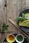 Vietnamese savory fried pancake with vegetables and ingredients on wooden table — Stock Photo