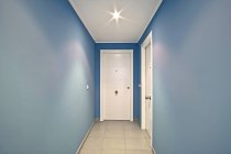 Interior of modern blue corridor with white doors — Stock Photo