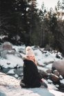 Smiling woman at river in winter — Stock Photo