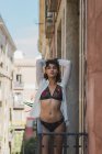 Slim girl in stylish underwear on balcony — Stock Photo