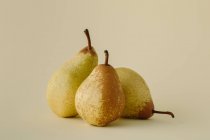 Three ripe juicy pears on gray background — Stock Photo