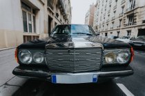 Black vintage car parked on the street in Paris, France. — Stock Photo