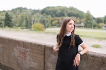 Jovem mulher elegante em vestido preto ao ar livre — Fotografia de Stock