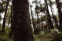 Persona sdraiata su un'amaca verde tra gli alberi della foresta in Cantabria, Spagna — Foto stock
