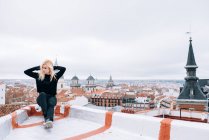 Young blonde woman standing in rooftop — Stock Photo