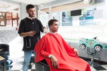 Moroccan man working at his hairdresser — Stock Photo
