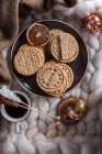 Tasty homemade cookies and cup of coffee on plaid with christmas ornaments — Stock Photo