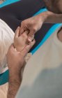 Close-up of therapist massaging female hand — Stock Photo