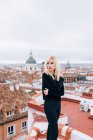 Молодая блондинка стоит на крыше — стоковое фото