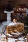 Tasty sweet cake with snowflake decoration on wooden table — Stock Photo