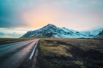 Amazing snowy mountain view from road with sunrise — Stock Photo