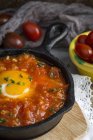 Huevo frito con tomate y pimientos rojos en sartén - foto de stock