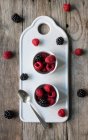 Blackberries and raspberries in bowls — Stock Photo