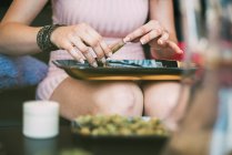 Woman preparing marijuana in a bong — Stock Photo